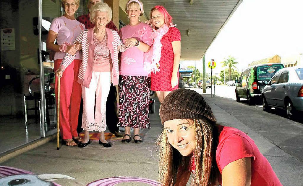 Artist Amelia Batchelor whips up some impressive chalk art for a breast cancer fundraiser with Strands staff Jeni Harvey, Steve Tierney, Silvia Fairlie, Bronwyn Galante and Tegan Smith.